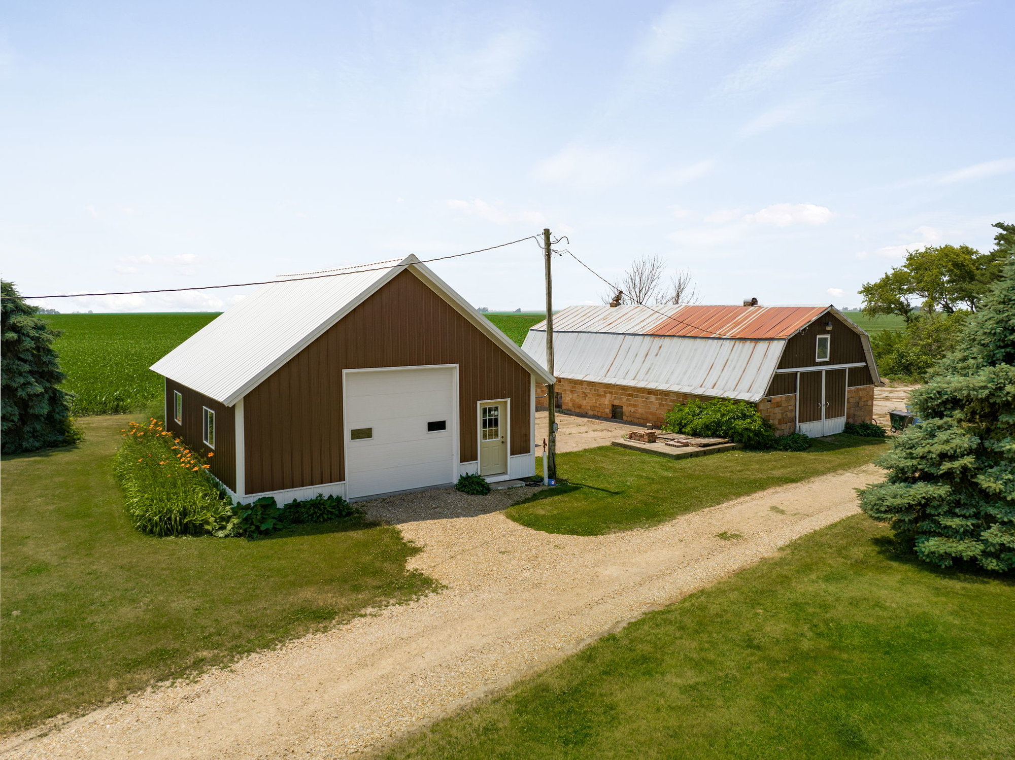 Enjoy Quiet Country Living in a Convenient Location Just Outside of the Cedar Valley - 13014 Gibson Rd., Hudson 3 Bedrooms | 2 Bathrooms | 2,396 Square Feet | 4.08 Acres | 3 Stall Garage | $369,900  Listed by Sara Wegmann, 319.269.4755  Best of both worlds! Enjoy quiet country living with very minimal gravel on this acreage just outside of Cedar Valley. Updates & amenities galore including: private & fenced side yard, water proofed lower level, main floor laundry & bathroom, bonus playroom, enclosed porch, pantry, and triple attached garage. Even better is the BIG bonus in the newly finished, heated/insulated full wired workshop with a 220 outlet perfect for a workshop or entertaining. Established rhubarb, asparagus, blackberries & raspberry bushes, apple & pear trees. Excellent storage throughout! 